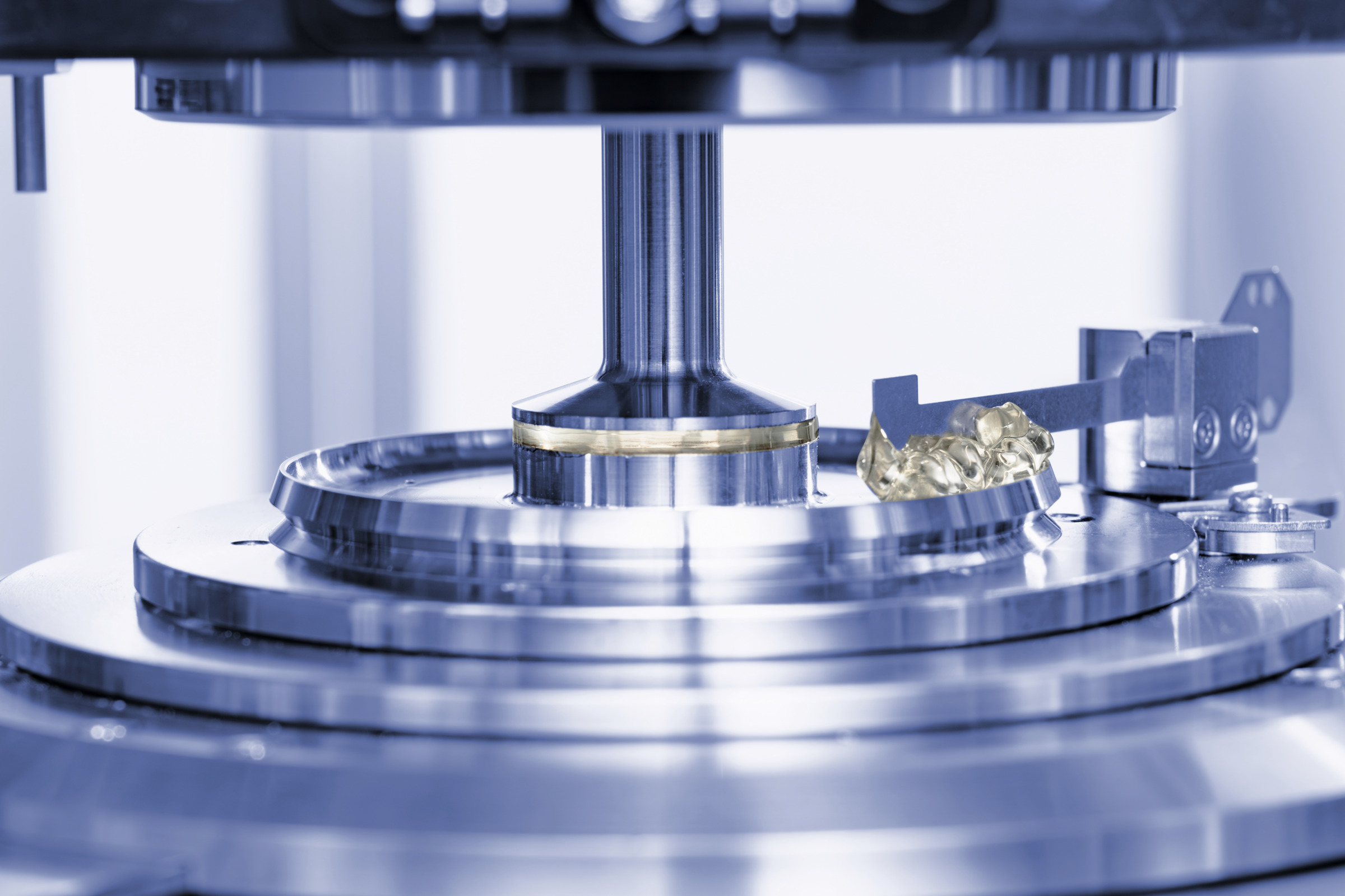 Close-up of Anton Paar HTR 7000 automated testing system measuring soft gel capsules with integrated compression fixture