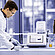 Lab technician using Anton Paar DMA 5002, Alcolyzer 3001, Xsample 3100, and Enzymatic Reader in a beer analysis laboratory.