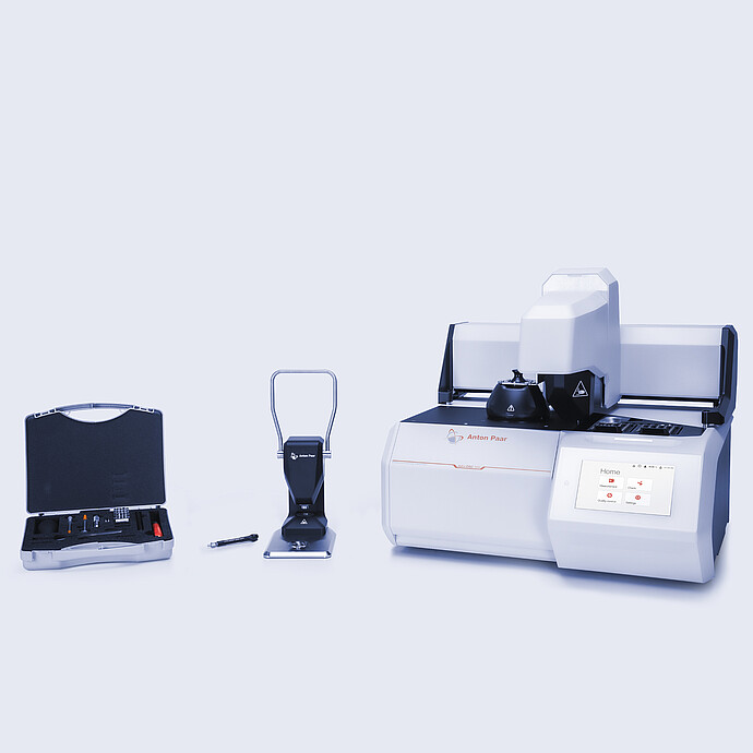 Anton Paar Julia DSC 500 with automated sample changer, manual sample press, and accessory kit with tools arranged on a neutral background