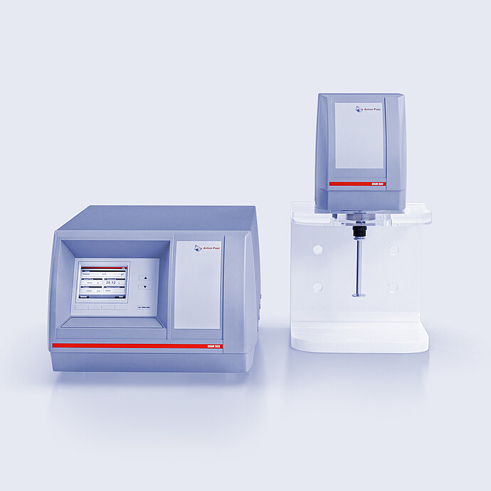 Anton Paar DSR 502 control unit and DSR 502 measuring head on a stand with spindle, shown against a light gray background