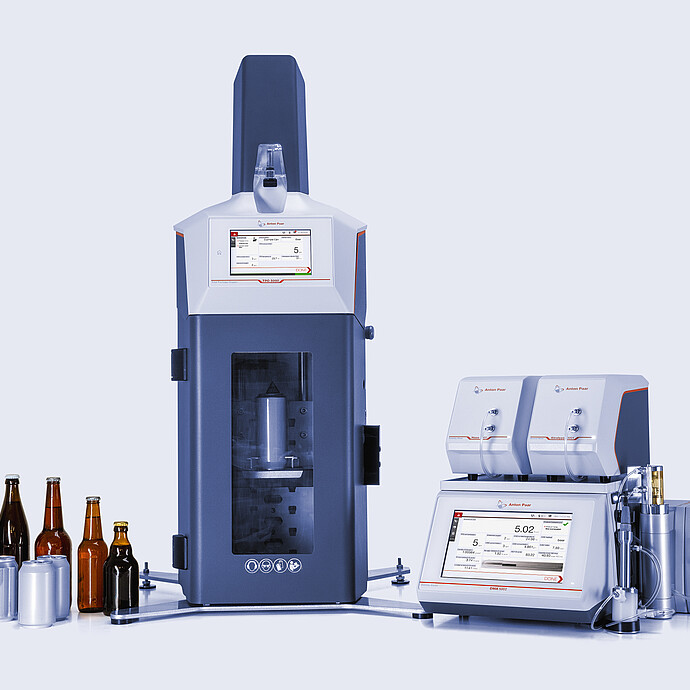 Anton Paar TPO 5000 with open chamber connected to DMA 5002 with Alcolyzer and Haze modules, beer bottles and cans beside instruments