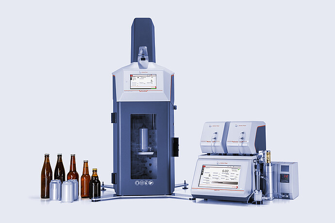 Anton Paar TPO 5000 with open chamber connected to DMA 5002 with Alcolyzer and Haze modules, beer bottles and cans beside instruments