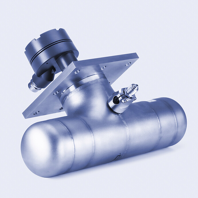 Aerial view of an industrial tank farm with multiple horizontal storage vessels arranged in parallel, connected by piping, valves, and elevated pipe racks