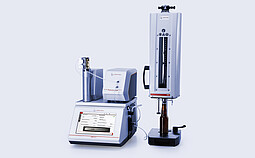 Anton Paar DMA 6002 SV with Alcolyzer 3001 Spirits and CarboQC ME with Option O2, connected to PFD filling device with glass bottle positioned under filling head