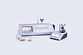 MCP Sucromat polarimeter and Abbemat refractometer with sugar samples and glassware for measuring sugar content, dry substance, and purity.