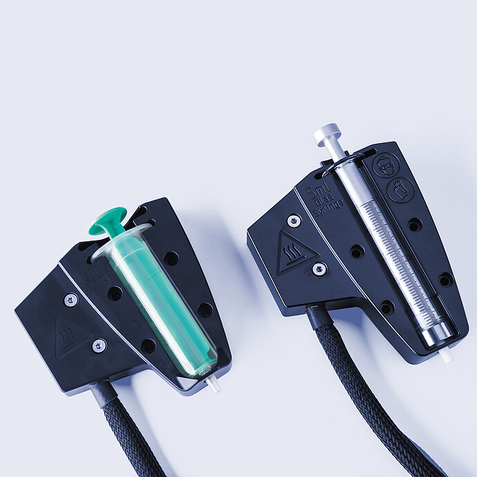 Two heated syringe holders for Anton Paar Xsample 610 sample changer with 10 mL and 5 mL syringes and black cables