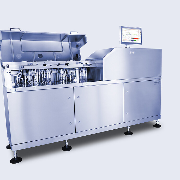 Angled view of Brabender TwinLab B-TSE-S-30-40 twin-screw extruder with open process section, visible piping and modules, and touchscreen