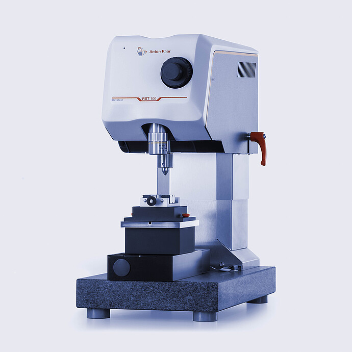 Side view of the Anton Paar Revetest® Scratch Tester RST 100, showing the control head, indenter, and base used for material surface testing.