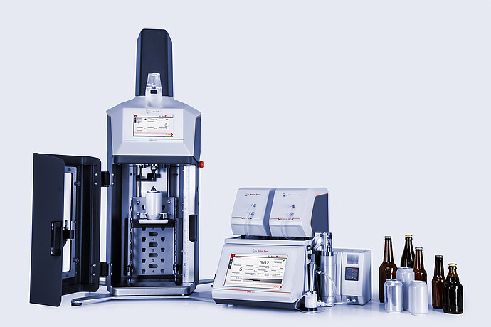 Anton Paar TPO 5000 with open chamber connected to DMA 5002 with Alcolyzer and Haze modules, beer bottles and cans beside instruments