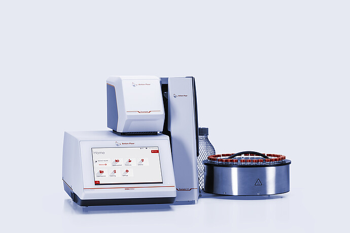 Anton Paar DMA 5002 density meter with Xsample Heating Controller and Xsample 631 sample changer, red-capped vial carousel, and bottle