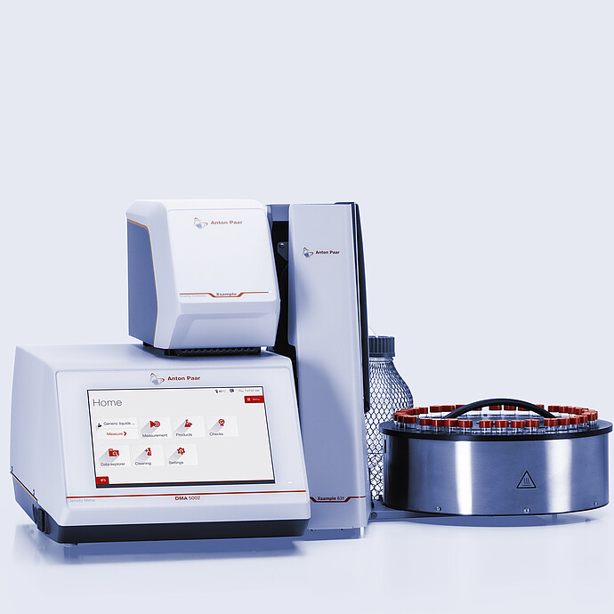 Anton Paar DMA 5002 density meter with Xsample Heating Controller and Xsample 631 sample changer, red-capped vial carousel, and bottle