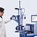 Laboratory technician pours sample pieces into the feed hopper of a Brabender MetaStation 4E modular torque rheometer with graph display.