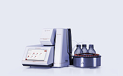 Anton Paar DMA 5002 density meter with Xsample 631 sample changer, vial carousel, bottles, tubing, and Xsample module