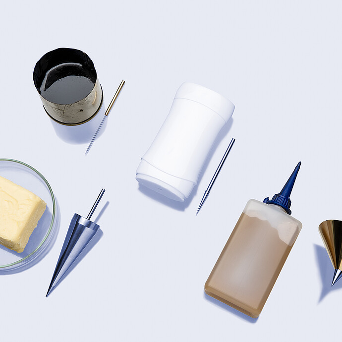 Various sample materials with test cones and needles for the Anton Paar Penetrometer PNR 500, including butter, grease, and a deodorant stick.