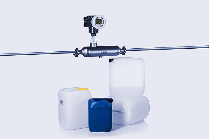 The Type S L-Cor 6000 Coriolis mass flow meter next to chemical samples