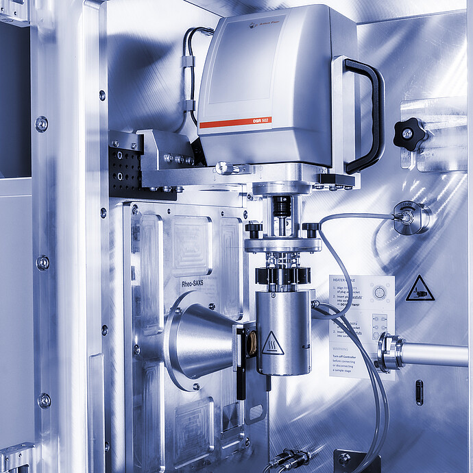 Anton Paar DSR 502 measuring head installed in a Rheo-SAXS setup with cables and a cylindrical sample component