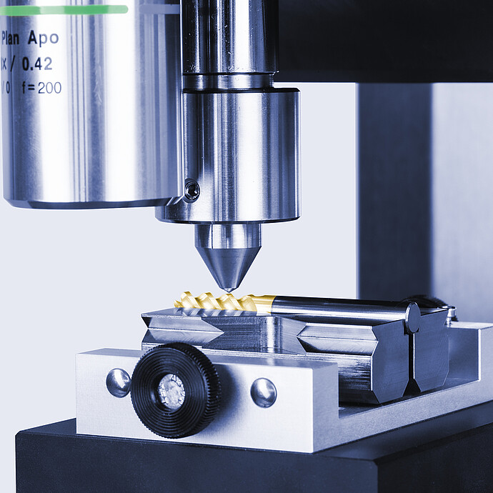 Close-up of the Anton Paar Revetest® Scratch Tester RST 100 indenter positioned above a sample secured in a precision clamp.