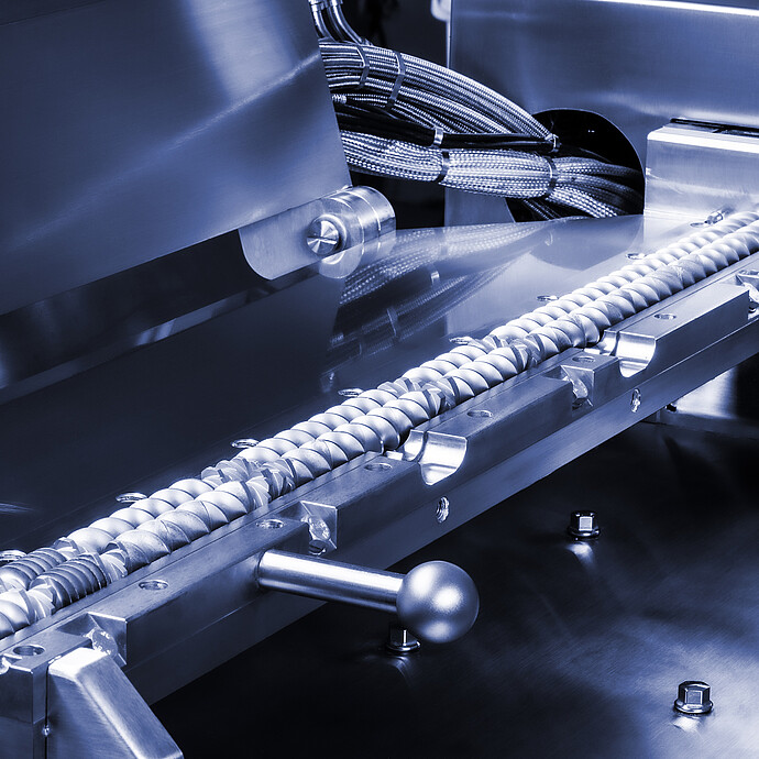 TwinLab Series Brabender extruder with opened barrel, showing twin screws, metal housing, and bundled heating cables.
