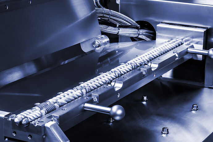 TwinLab Series Brabender extruder with opened barrel, showing twin screws, metal housing, and bundled heating cables.