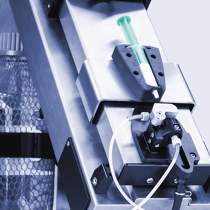 Anton Paar Xsample 340 sample changer with 5 mL syringe, cleaner port, tubing, and bottle held in side bracket