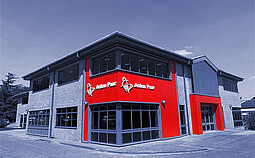 Anton Paar Ltd building in Luton, UK, two-story office and laboratory facility with red Anton Paar logo panels on the facade
