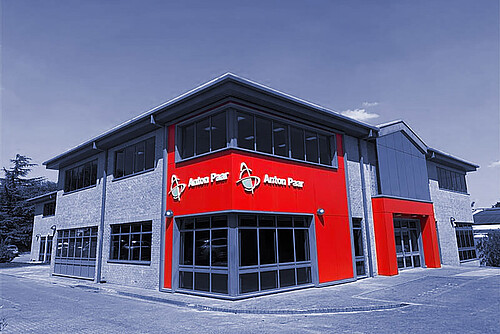 Anton Paar Ltd building in Luton, UK, two-story office and laboratory facility with red Anton Paar logo panels on the facade