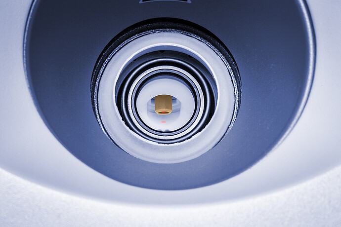 Close-up view of the reaction vessel inside the Anton Paar Monowave 400 R microwave synthesis reactor. A red laser spot indicates in-situ Raman spectroscopy measurement, providing real-time molecular analysis during chemical reactions.