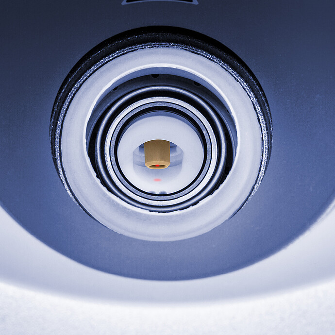 Close-up view of the reaction vessel inside the Anton Paar Monowave 400 R microwave synthesis reactor. A red laser spot indicates in-situ Raman spectroscopy measurement, providing real-time molecular analysis during chemical reactions.