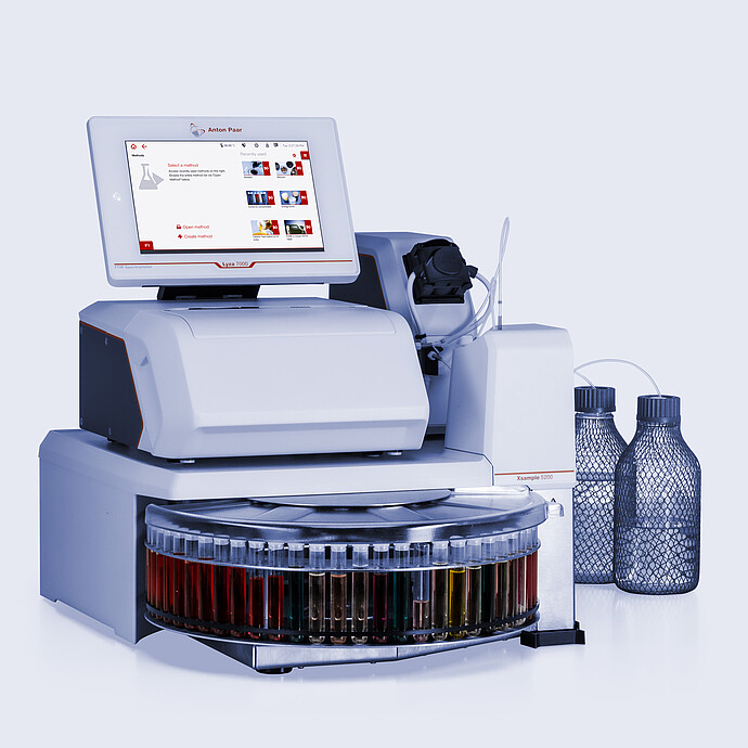 Anton Paar Lyza 7000 FTIR spectrometer with Lyza Flow Cell and Xsample 5200 autosampler, sample carousel, tubing, and two bottles.