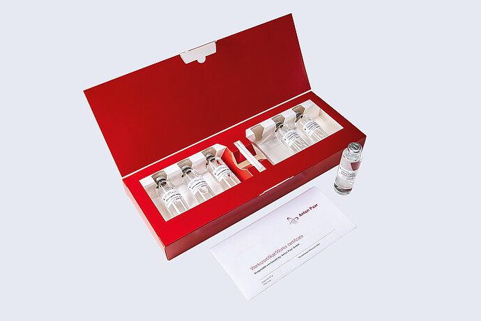 Open red Anton Paar Standards kit with glass vials, one vial beside the box, and a works certificate.