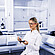 Technician holding sample tray and crucible in laboratory with Anton Paar Julia DSC 300 and Julia DSC 500, both with integrated touchscreens