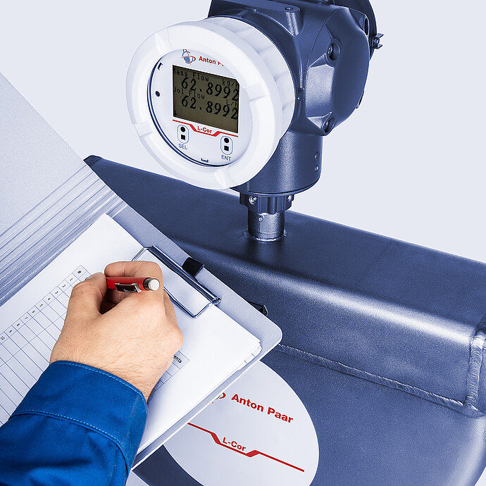 An operator working with a checklist and the Type B L-Cor 4000 Coriolis mass flow meter