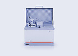 Anton Paar High Temperature Tribometer THT with open protective cover and pin-on-disk test setup on a white background