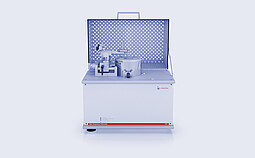 Anton Paar High Temperature Tribometer THT with open protective cover and pin-on-disk test setup on a white background