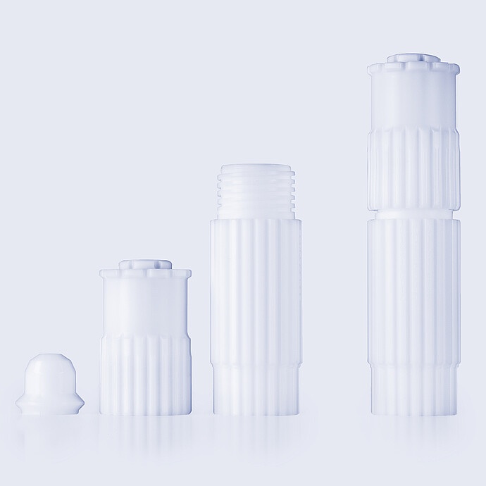 Four microwave digestion vessel components arranged upright on a light background.