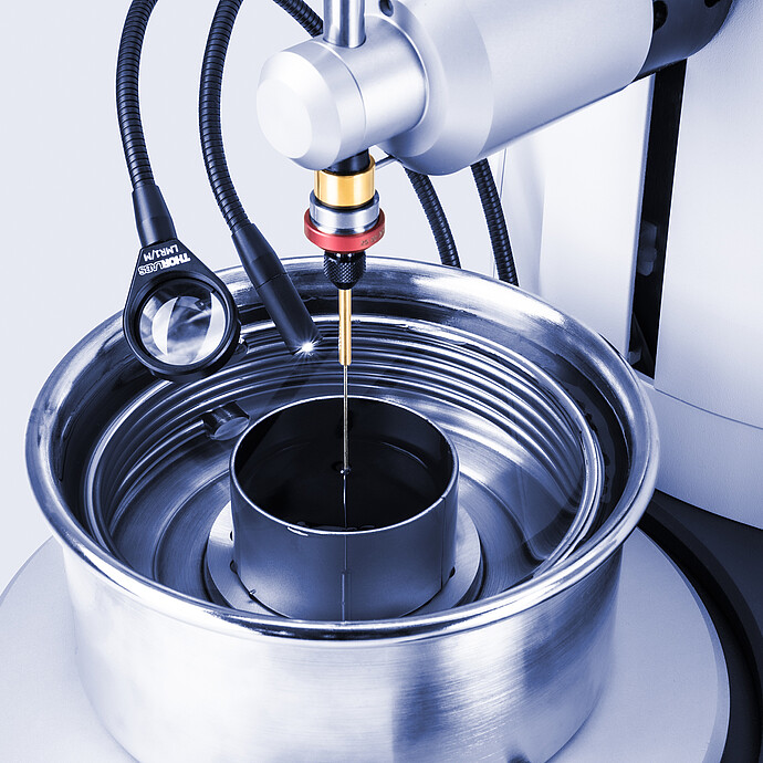 Close-up of Anton Paar Penetrometer PNR 500 with needle probe above sample in test vessel, illuminated by external light guides.