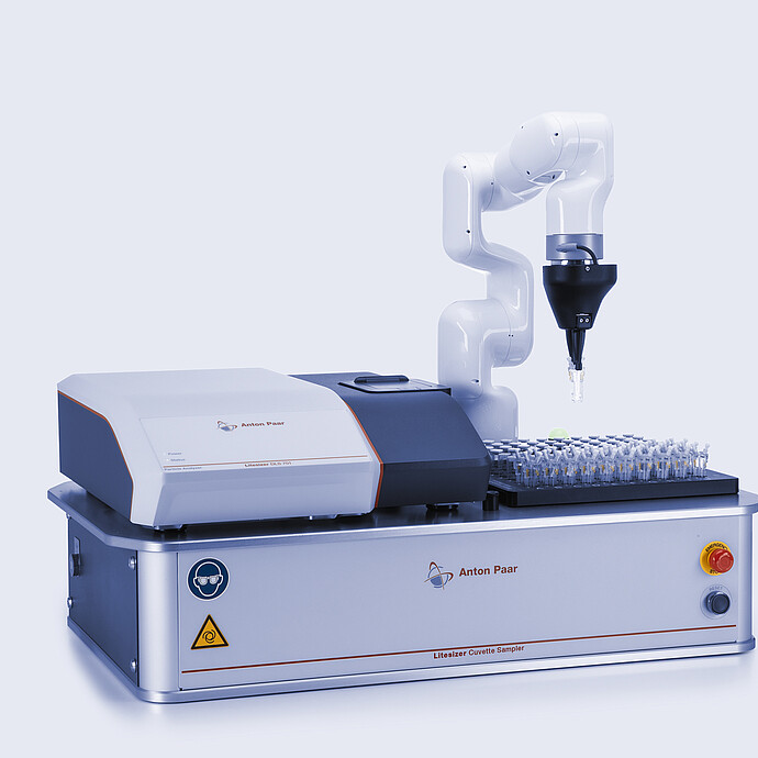 Litesizer DLS 701 nanoparticle analyzer combined with Litesizer Cuvette Sampler, showing a robotic arm lifting a cuvette from a sample tray on an Anton Paar automation platform.