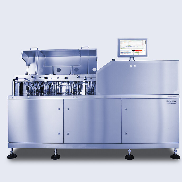 Brabender TwinLab B-TSE-S-30-40 twin-screw extruder with opened processing section showing piping and modules, plus touchscreen control unit