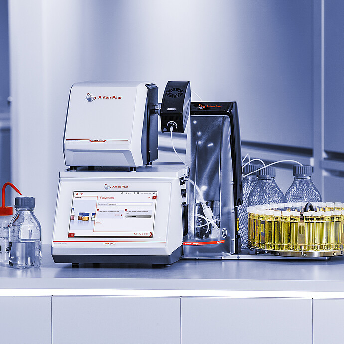 Anton Paar DMA 5002 density meter with Lovis 2000 M/ME and Xsample 530 sample changer, vial carousel, bottles, and tubing