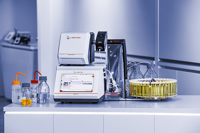 Anton Paar DMA 5002 density meter with Lovis 2000 M/ME and Xsample 530 sample changer, vial carousel, bottles, and tubing