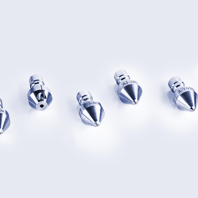 Various indenter tips for the Anton Paar Revetest® Scratch Tester, displayed in a row, featuring different shapes and sizes for specific testing applications.