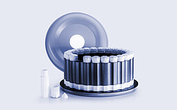 HVT Rotor with circular arrangement of sealed digestion vessels, removed lid positioned behind, and individual vessel components on a light background