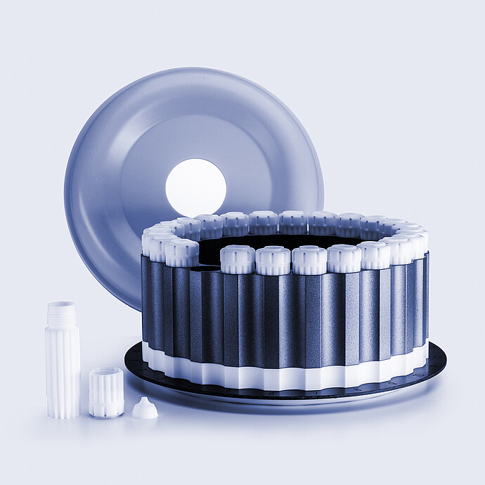 HVT Rotor with circular arrangement of sealed digestion vessels, removed lid positioned behind, and individual vessel components on a light background