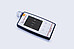 Anton Paar Cora 101 handheld Raman spectrometer lying on a flat surface with its display showing scan menu options.