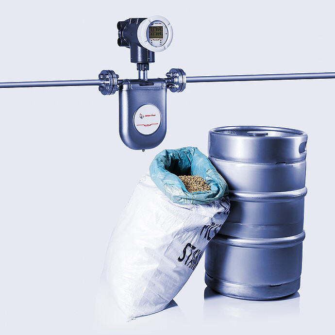 The Type U L-Cor 8000 Coriolis mass flow meter next to beer brewing samples