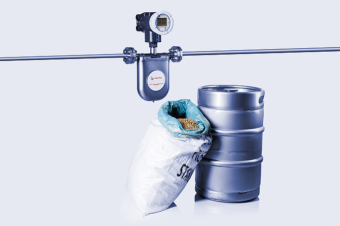 The Type U L-Cor 8000 Coriolis mass flow meter next to beer brewing samples