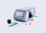 Anton Paar SVM 3001 rotational viscometer with Hot Filling Attachment mounted on the filling port, shown with syringes, filling accessories, and a beaker containing heated high-viscosity sample.