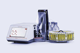 Anton Paar DMA 5002 density meter with Xsample 530 sample changer, vial carousel, bottles, tubing, and clear front cover