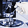 Gloved hand adds polymer pellets to the measuring cup of an Anton Paar SmartMelt polymer melt rheometer.