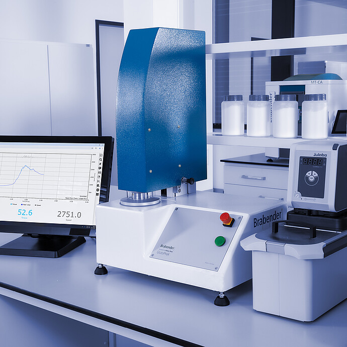 Brabender GlutoPeak analyzer with Julabo temperature control unit and data display on monitor, set up in a laboratory environment.